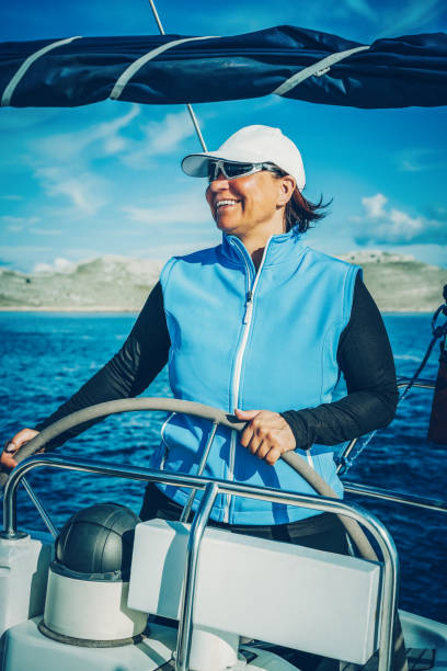 woman skipper sailing a sailboat - vessel part imagens e fotografias de stock