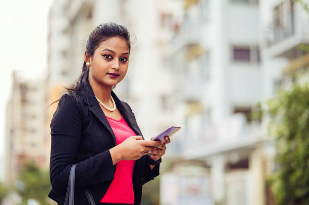 istock Beautiful Indian woman sending message with phone 1391639836