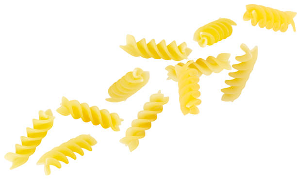 istock Italian pasta penne rigate spiral shape flying in space isolated on white 1391640456