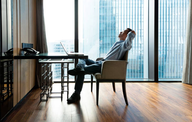 istock Businessman leaning on chair with hands behind head 1391640735