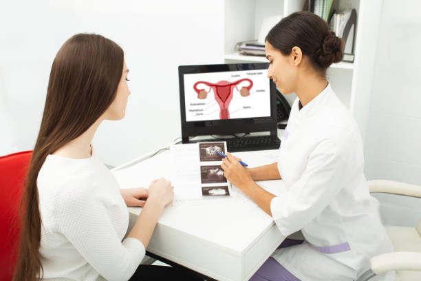 Gynecology, consultation of gynecologist, women's health. Gynecologist showing to woman ultrasound of her ovaries during female patient visit to gynecology Gynecology, consultation of gynecologist, women's health. Gynecologist showing to woman ultrasound of her ovaries during female patient visit to gynecology Ovulation stock pictures, royalty-free photos & images