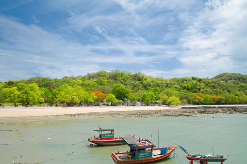 Coast of Koh Sichang  near public park at Phra Chudahut Ratchathan Palace and Koh Sichang anchorage. In foreground are some fisher boats