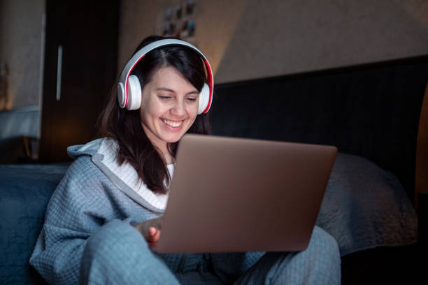 istock woman in headset working on laptop has video call 1391642662