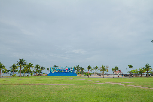 Panorama of public park at coast in Siracha in Chonburi province at early morning. A few people are exercising and jogging in background