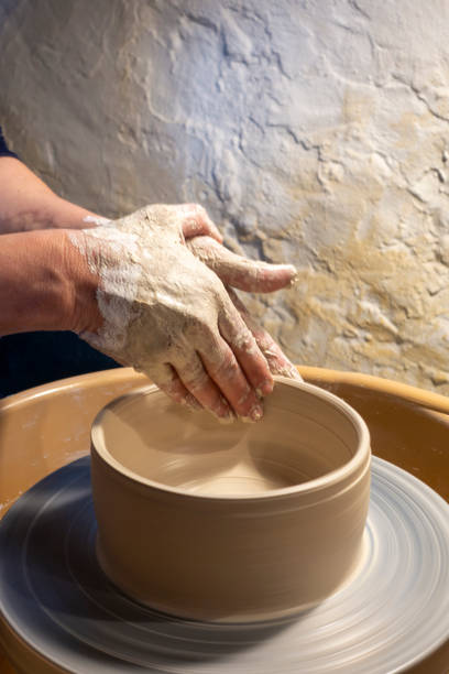 nahaufnahme von händen, die mit ton auf dem drehteller-handwerker arbeiten - keramiker stock-fotos und bilder