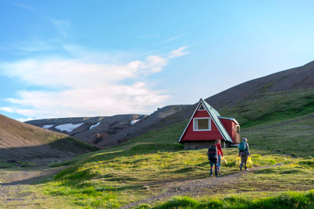Senior women, tourists at Highlands camping Kerlingarfjoll on Iceland Senior women caring bags with food at Kerlingarfjoll resort, Camping and and cabin house.  Trail within 4 hours to geothermal area. kerlingarfjoll stock pictures, royalty-free photos & images