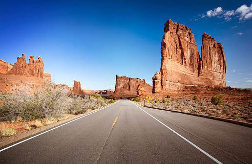 Empty road with the Monument Valley in the background