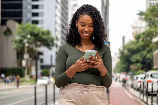 istock Woman using smart phone in the city. 1391651688
