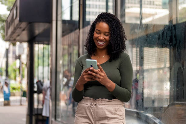 istock Woman using smart phone in the city. 1391651694