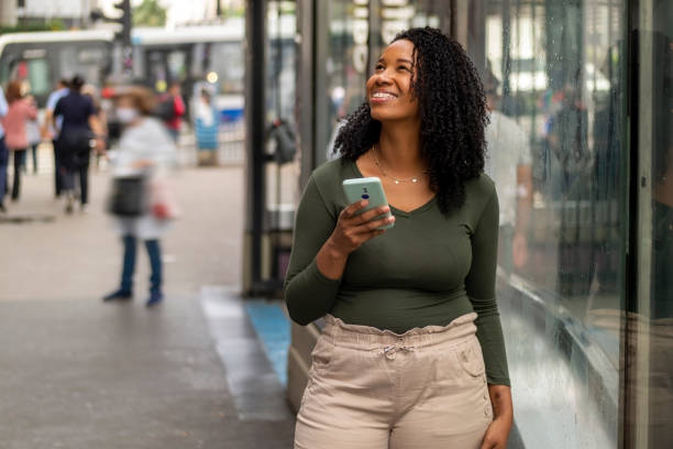 istock Woman using smart phone in the city. 1391651698