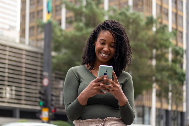 istock Woman using smart phone in the city. 1391651755