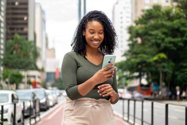 istock Woman using smart phone in the city. 1391651797