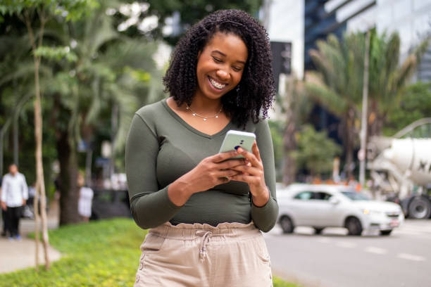 istock Woman using smart phone in the city. 1391651843