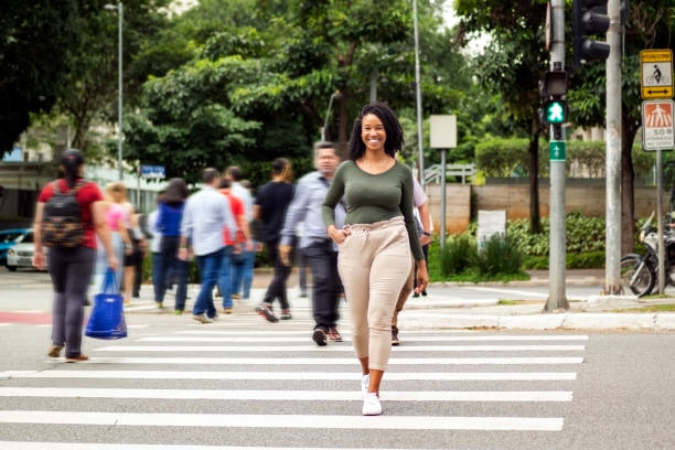Woman crossing Faria Lima Avenue in Sao Paulo city. stock photo