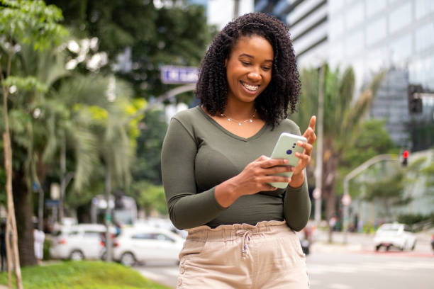 istock Woman using smart phone in the city. 1391652010