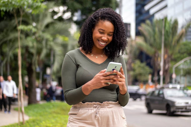 istock Woman using smart phone in the city. 1391652021