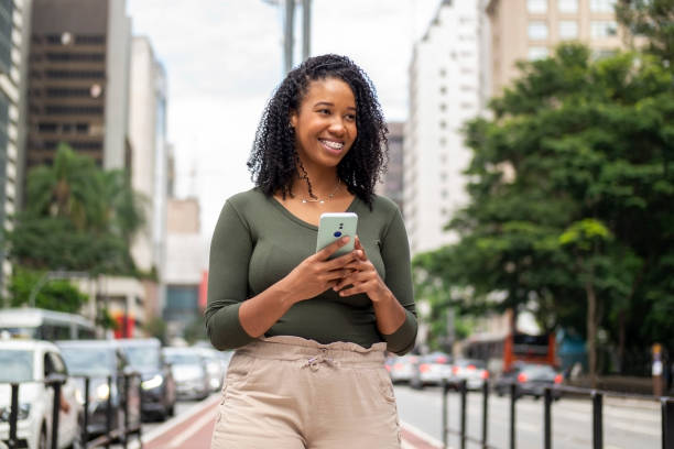 istock Woman using smart phone in the city. 1391652599