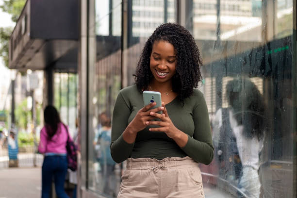 istock Woman using smart phone in the city. 1391652800
