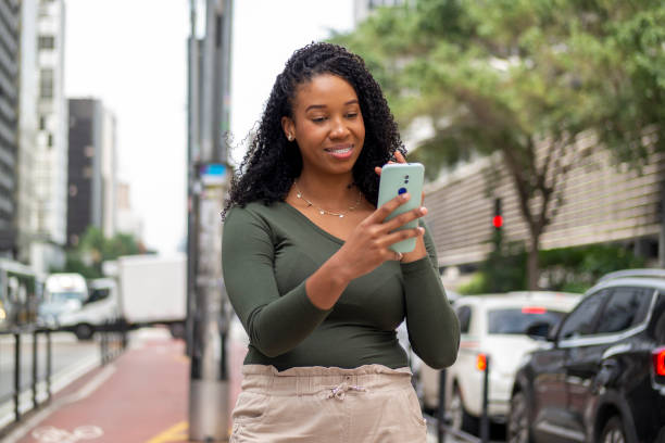 istock Woman using smart phone in the city. 1391652813