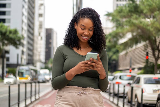 istock Woman using smart phone in the city. 1391652827