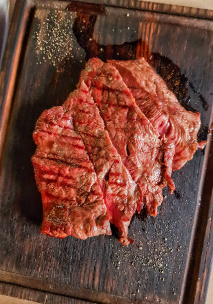 istock Roast beef steak of medium roast on a wooden board. 1391654920
