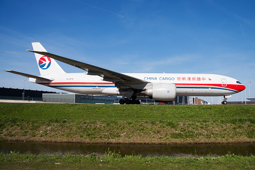 Amsterdam, Netherlands - April 12, 2015: China Eastern cargo plane at airport. Air freight and shipping. Aviation and aircraft. Transport industry. Global international transportation. Fly and flying.