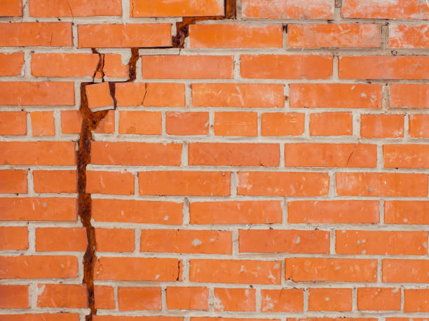 istock brick wall cracked, brick wall cracked with mounting foam 1391654964