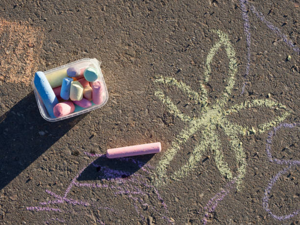 istock children's drawings with chalk on the pavement and scattered chalk 1391655035