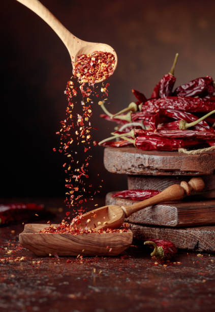 istock Chilli flakes are poured into a wooden dish. 1391657473