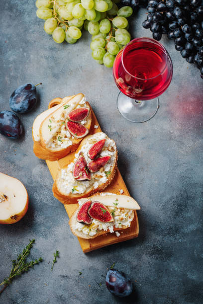 istock red wine with snacks bruschetta with pears, cottage cheese, figs, thyme, nuts and honey, camembert cheese. 1391659438