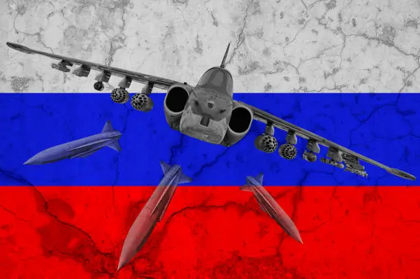 Photo of Russia aggressor. Abstract russian flag behind supersonic missile bomber jet with missiles. War aggression conflict concept