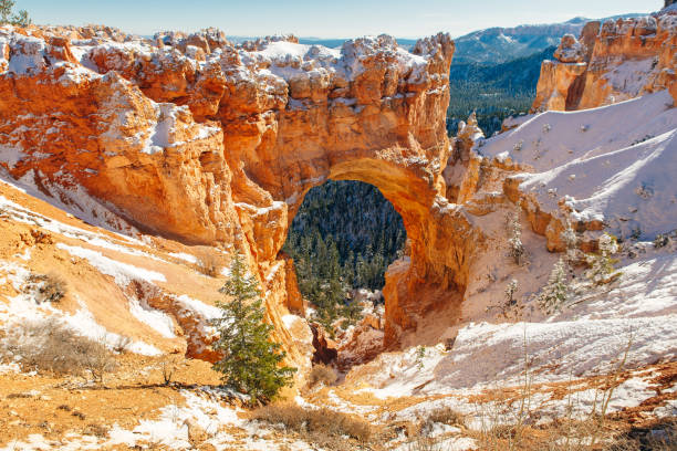 istock Natural Stone Bridge, Arch at Bryce Canyon with snow 1391663941