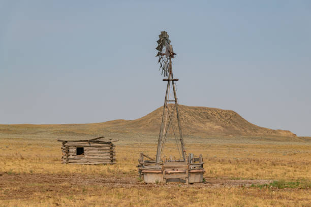 istock Log cabin building and windmill with mesa butte in background 1391670621