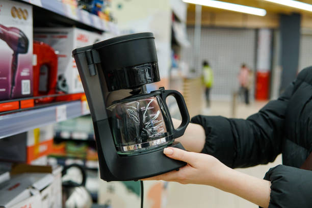 istock Woman customer choosing new coffee machine at store. Close up. 1391673102