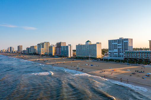 Aerial View of the skyline of the Virginia Beach Oceanfront looking South. hotels and condos along the beach during golden hour seen from the ocean