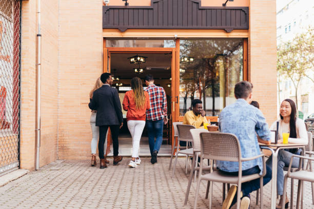 istock 4 multiethnic people arriving at a restaurant 1391674458