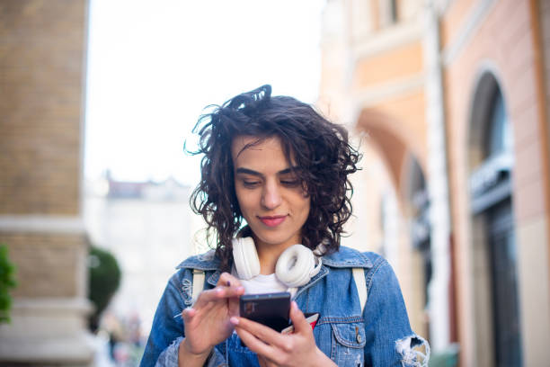 istock Happy young woman using phone 1391675468
