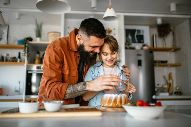 istock Little girl making and decorating cake with her father 1391679679