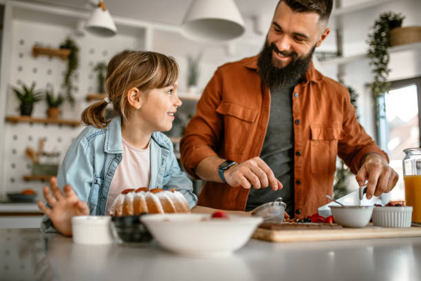 istock Family decorating cake with fruits and nuts 1391679777