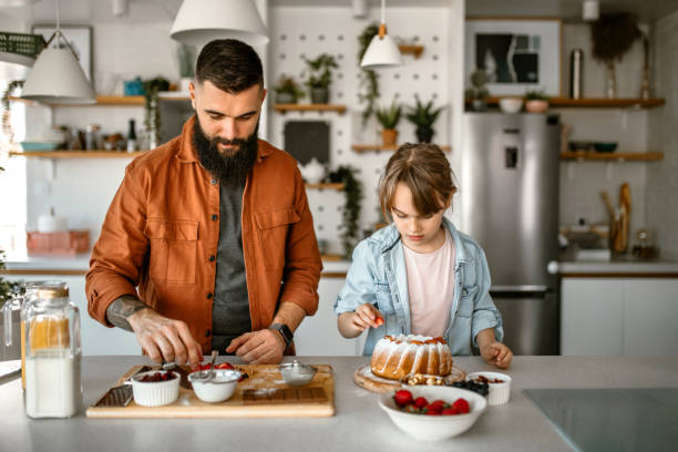 istock Family decorating cake with fruits and nuts 1391679795