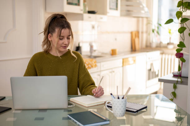 istock Woman working from a home on her a laptop 1391682760