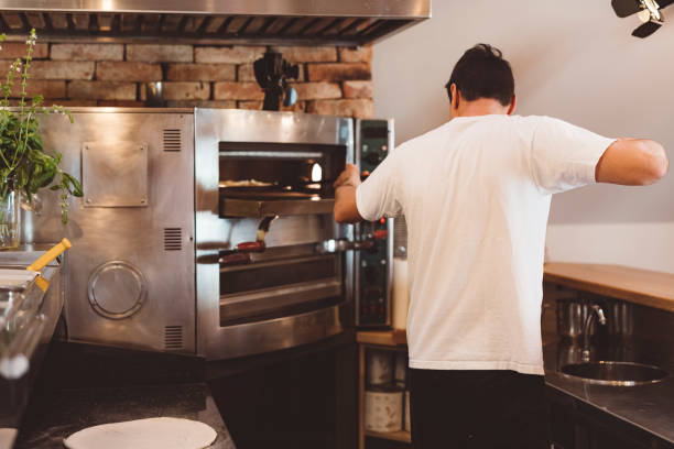 istock Chaf using pizza peel to put pizza in the oven 1391685315