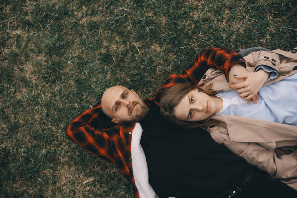 istock young couple laying on grass. summer love 1391689037
