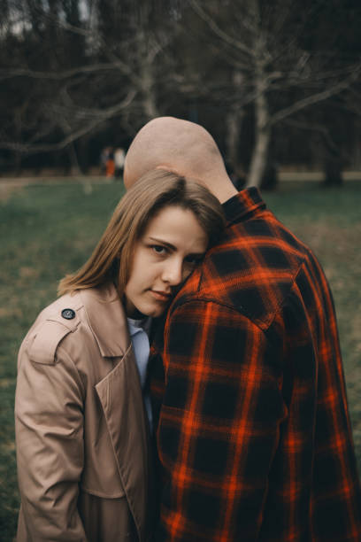 istock Loving couple embrace with each other. Tree on background 1391689126