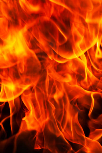 istock orange flame of fire while burning branches and firewood 1391690910
