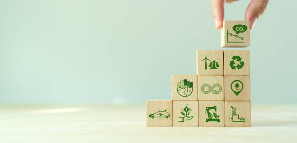 istock Low carbon,carbon neutral concept. Net zero greenhouse gas emissions target. Climate neutral long term strategy. Hand put wooden cubes with decrease carbon emission icon and green icon. Green banner. 1391695735