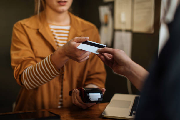 istock Customer gives a payment card 1391696684