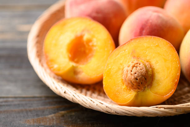 istock Peach fruit in basket on wooden background 1391698753