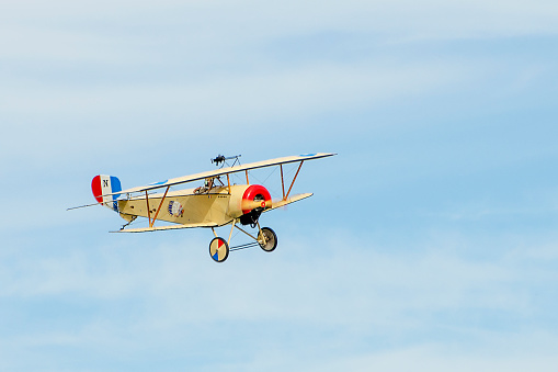 Dayton, Ohio, USA - September 27, 2014: Replica Nieuport 17 World War 1 biplane in French Escadrille de La Fayette military colors being flown at the World War I Dawn Patrol Rendezvous fly-in at Wright Air Field.