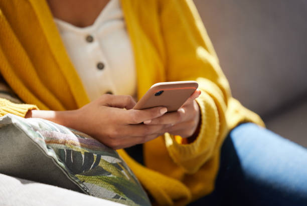 istock Shot of an unrecognizable person using a phone at home 1391708015